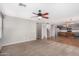 Carpeted living room with ceiling fan and view of the kitchen at 15466 W Shangri La Rd, Surprise, AZ 85379