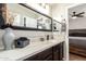 Stylish bathroom with a large mirror over a single vanity and white countertop at 16993 W Shiloh Ave, Goodyear, AZ 85338