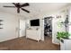 Bright bedroom with a ceiling fan, closet, a dresser and an ensuite bathroom at 16993 W Shiloh Ave, Goodyear, AZ 85338