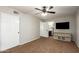 A spacious bedroom featuring neutral tones, a ceiling fan, closet and ensuite bathroom access at 16993 W Shiloh Ave, Goodyear, AZ 85338