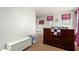 Cozy bedroom featuring a dark wood bed frame, and decorated with pink and black accents at 16993 W Shiloh Ave, Goodyear, AZ 85338