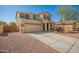 Two-story home with desert landscaping, a charming front porch swing, and a two-car garage at 16993 W Shiloh Ave, Goodyear, AZ 85338