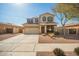 Two-story home featuring a charming front porch swing, a two car garage, and desert landscaping at 16993 W Shiloh Ave, Goodyear, AZ 85338