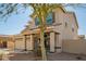 Two-story home featuring a charming front porch swing, neutral toned exterior, and desert landscaping at 16993 W Shiloh Ave, Goodyear, AZ 85338