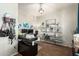 Well-lit home office with dual monitors, decorative shelving, and comfortable desk chair at 16993 W Shiloh Ave, Goodyear, AZ 85338