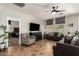 Comfortable living room featuring a ceiling fan and an opening into the Primary bedroom at 16993 W Shiloh Ave, Goodyear, AZ 85338