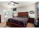 Main bedroom featuring a large dark wood bed frame and adjoining Primary bathroom at 16993 W Shiloh Ave, Goodyear, AZ 85338