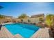 Beautiful backyard pool with brick surround, mature trees, and inviting lounge area at 16993 W Shiloh Ave, Goodyear, AZ 85338