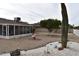 Well-maintained backyard with gravel, cacti, citrus tree, fountain, and privacy fence at 17626 N Buntline Dr, Sun City West, AZ 85375