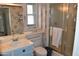 Cozy bathroom featuring a walk-in shower, neutral color palette, and a single sink vanity at 17626 N Buntline Dr, Sun City West, AZ 85375