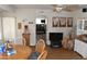 Open dining area with a round table, ceiling fan, and views to office at 17626 N Buntline Dr, Sun City West, AZ 85375