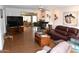 Spacious living room with laminate floors seamlessly connects to the dining area at 17626 N Buntline Dr, Sun City West, AZ 85375