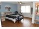 Serene main bedroom with light blue walls, laminate flooring, and a calming atmosphere at 17626 N Buntline Dr, Sun City West, AZ 85375