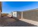 Backyard featuring gravel landscaping, secure storage shed, and privacy fence at 1781 S 223Rd Dr, Buckeye, AZ 85326