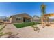 Spacious backyard featuring a well-maintained lawn, pergola, desert landscaping, and a trampoline at 1781 S 223Rd Dr, Buckeye, AZ 85326