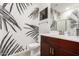 Stylish powder room with a modern vanity, a toilet, and unique wallpaper at 1781 S 223Rd Dr, Buckeye, AZ 85326