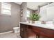 Bathroom with dual sinks, decorative plants and modern lighting at 1781 S 223Rd Dr, Buckeye, AZ 85326