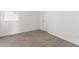 Minimalist bedroom featuring soft carpet, white walls, and abundant natural light at 1781 S 223Rd Dr, Buckeye, AZ 85326