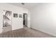 Neutral bedroom with soft carpet, white walls, and modern black and white artwork at 1781 S 223Rd Dr, Buckeye, AZ 85326