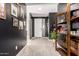 Stylish foyer with decorative shelving, tile flooring, and a view of the front door at 1781 S 223Rd Dr, Buckeye, AZ 85326