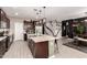 Kitchen island with pendant lighting, bar seating, and stainless steel sink at 1781 S 223Rd Dr, Buckeye, AZ 85326