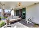 Backyard patio with an outdoor sofa, Adirondack chair, ceiling fans, and sliding glass doors at 1837 E Coolidge St, Phoenix, AZ 85016