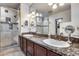 Bathroom vanity with dual sinks, granite counters, framed mirrors, and glass enclosed shower at 1837 E Coolidge St, Phoenix, AZ 85016