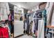 Walk-in closet with custom shelving, drawers and multiple rows of hanging clothes at 1837 E Coolidge St, Phoenix, AZ 85016