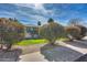 Charming home exterior featuring lush, manicured bushes, a green lawn and a sunny blue sky backdrop at 1837 E Coolidge St, Phoenix, AZ 85016