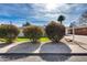 Charming home exterior featuring lush, manicured bushes, a green lawn and a sunny blue sky backdrop at 1837 E Coolidge St, Phoenix, AZ 85016