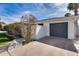 Exterior side view of a home featuring a well-maintained yard and an attached garage at 1837 E Coolidge St, Phoenix, AZ 85016