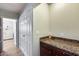 Hallway featuring brown granite countertops on the cabinetry and hardwood flooring at 1837 E Coolidge St, Phoenix, AZ 85016