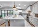 Bright kitchen features a large island with white countertop, seating, modern appliances, and gold pendant lights at 1837 E Coolidge St, Phoenix, AZ 85016