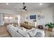 Open-concept living room with shiplap walls, a modern sofa, and seamless access to the kitchen at 1837 E Coolidge St, Phoenix, AZ 85016