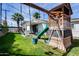 Backyard play set featuring swings, slide, rock-climbing wall, and an outdoor patio area at 1837 E Coolidge St, Phoenix, AZ 85016