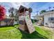 Backyard play set on the grass with a rock wall, slide, and swing set at 1837 E Coolidge St, Phoenix, AZ 85016