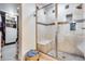 Tiled glass-enclosed shower with bench seating and a view of the walk-in closet at 1837 E Coolidge St, Phoenix, AZ 85016