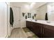 Bathroom featuring a double sink vanity with sleek, modern cabinetry and tiled floors at 18501 W Galveston St, Goodyear, AZ 85338