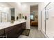 Bathroom providing a view to the adjacent main bedroom and a stylish glass-enclosed shower at 18501 W Galveston St, Goodyear, AZ 85338