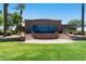 Exterior view of the community brick building with architectural steps, manicured lawns, and mature trees at 18501 W Galveston St, Goodyear, AZ 85338