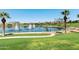 Beautiful community lake featuring fountains, lush landscaping, walking paths and clear blue skies at 18501 W Galveston St, Goodyear, AZ 85338