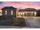 Beautiful single-story home with desert landscaping and a two-car garage at dusk at 18501 W Galveston St, Goodyear, AZ 85338