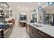 Open concept kitchen with center island and stainless appliances flowing into the dining and living areas at 18501 W Galveston St, Goodyear, AZ 85338