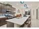 Open concept kitchen featuring island seating, quartz countertop, and stainless appliances at 18501 W Galveston St, Goodyear, AZ 85338