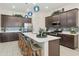 Bright kitchen featuring a large island with seating, modern appliances, stylish backsplash and unique pendant lighting at 18501 W Galveston St, Goodyear, AZ 85338