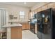 Well-lit kitchen featuring stainless steel appliances, ample cabinetry, and a gray countertop at 18501 W Galveston St, Goodyear, AZ 85338