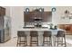 Bright open kitchen featuring island seating, quartz countertop, and stylish accents at 18501 W Galveston St, Goodyear, AZ 85338