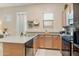 Modern kitchen with stainless steel appliances, a gray countertop, and wood cabinetry at 18501 W Galveston St, Goodyear, AZ 85338