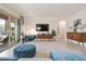 Sunlit living room with a modern media wall and view to an inviting outdoor patio with seating at 18501 W Galveston St, Goodyear, AZ 85338