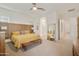 Bright main bedroom featuring a stylish ceiling fan, a modern bed frame, and ample natural light at 18501 W Galveston St, Goodyear, AZ 85338